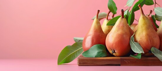 Canvas Print - Fresh pears and leaves arranged on a wooden board against a pink backdrop with copy space image