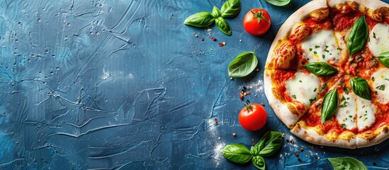 Sticker - Top down view of homemade margherita pizza with mozzarella fresh basil oregano and tomatoes on a blue textured background ideal for adding text or images copy space image