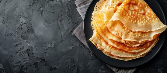 Poster - Tasty thin pancakes served on a sleek slate plate with copy space image