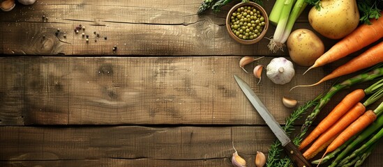 Poster - A wooden background with frame material including vegetables like potato carrot and garlic along with asparagus and a knife provides a visually appealing copy space image