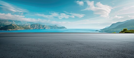 Poster - Scenic blue sky over an island landscape sea aside with an asphalt highway and copy space image