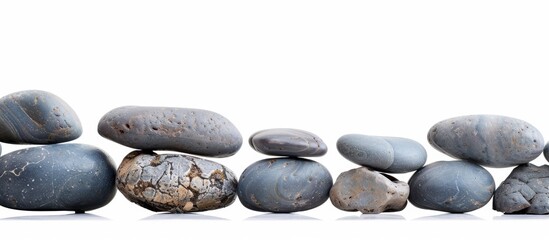 River rocks delicately balanced with copy space image on a white background