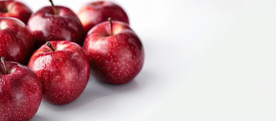Poster - Red apples displayed on a white backdrop with copy space image