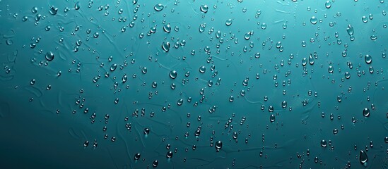 Poster - Raindrops on a textured blue background provide a perfect copy space image