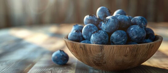 Poster - Blueberries displayed in a clean bowl on a wooden surface offering a spacious copy space image