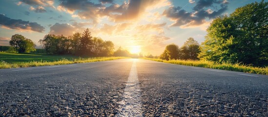 Poster - Scenic sunny spring evening countryside landscape with an open asphalt road and beautiful nature surrounding it perfect for copy space image