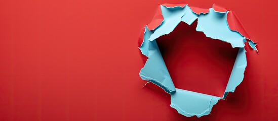 Aufkleber - A hole in light blue paper with a red background serves as a striking copy space image