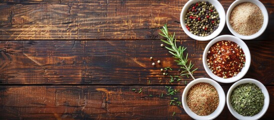 Poster - Top view of spices in small white bowls on a brown wooden backdrop suitable for pilaf ingredients with a vacant area for text like a copy space image