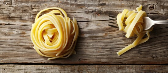 Poster - Pasta swirls with a fork on a rustic wooden backdrop create a captivating copy space image
