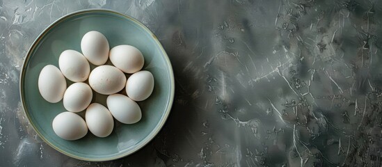 Poster - Directly above shot of white eggs in bowl on table with ample copy space for a fresh and healthy raw organic protein image