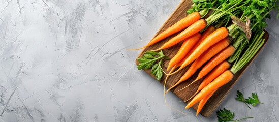 Poster - A wooden board displaying fresh carrots against a light backdrop with spacious copy space image