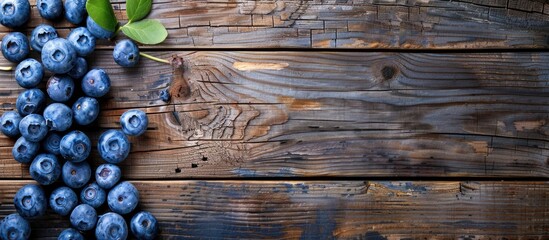 Poster - Top view high resolution image with blueberries on a wooden surface conveying a concept related to harvesting with space for duplication. copy space available