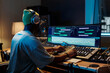 © pressmaster - Music producer working on mixing tracks in professional recording studio equipped with modern technology and audio equipment at nighttime