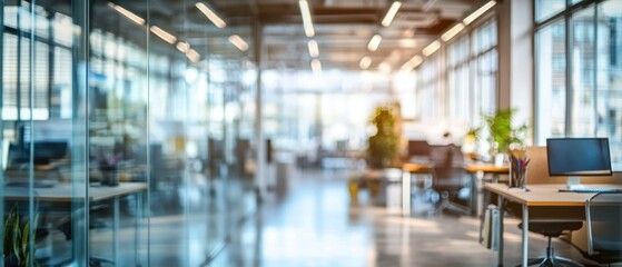 A blurred bright office background with glass walls, ergonomic chairs, and open desks, creating a spacious and modern working environment