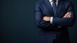 © Iswanto - Close up of a man's arms crossed wearing a dark blue suit jacket.