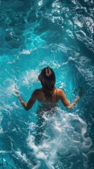 Poster - A woman is swimming in a pool with a lot of water splashing around her. The water is blue and the woman is wearing a bikini