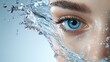 © Iswanto - Close up of a woman's blue eye with water splashing around it.