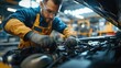 © PJ Gallery - Focused Mechanic Repairing Engine in Industrial Setting