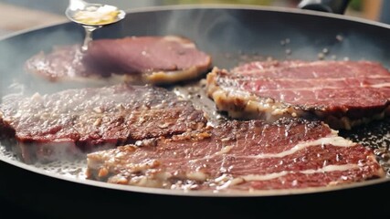 Wall Mural - A pan of meat is cooking on a stove. The meat is brown and has a lot of fat