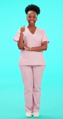 Poster - Thumbs up, pointing and arms crossed with a nurse black woman on blue background in studio for healthcare. Portrait, medical and a happy young female medicine professional in support of information