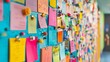 © nuttapong - A vibrant wall covered in colorful sticky notes, showcasing creativity and organization in a workspace or creative environment.