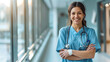 © Sourov - A smiling nurse standing confidently in a hospital corridor, holding a stethoscope