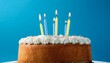 © Lee - fresh baked birthday cake with four candles blue back ground
