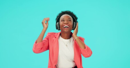 Poster - Music, dancing and black woman with headphones to listen in studio isolated on a blue background mockup space. Radio, streaming and happy person hearing podcast, sound or audio for moving with energy