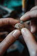 © SnowElf - A master jeweler setting gems into diamond ring, workshop with professional tools