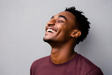 Poster - Close up profile happy young African American man laughing against gray background