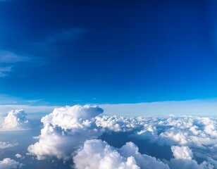 Wall Mural - A bright blue sky with fluffy white clouds viewed from above