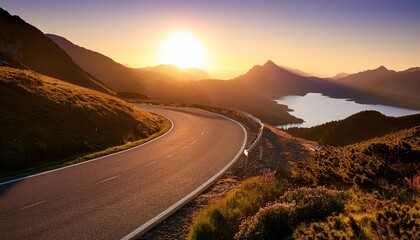 scenic winding road at sunset with stunning mountain and lake views offering a serene and picturesque travel experience