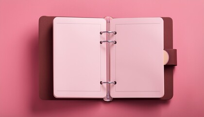 opened blank personal organizer on pink background