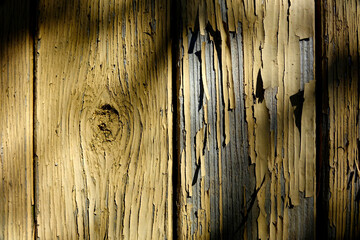 Poster - Old Wooden Wall With Cracked Paint Highlighting the Texture of Weathered Timber in Natural Light