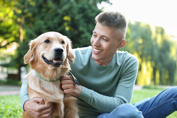 Wall Mural - Young man with his lovely dog in park