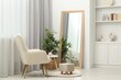© New Africa - Large mirror near white wall in room. Interior design