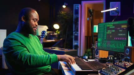 Poster - Modern producer playing piano keys to record new soundtrack, trying to produce song using midi controller electronic keyboard. Songwriter composer playing instrument notes to create tunes. Camera B.