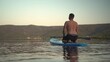 © Vital9c - Experience the Serene Joy of Paddleboarding at Sunset on the Calm, Peaceful Waters
