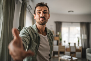 Wall Mural - close up portrait of adult man stand and smile at home