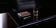 © Luluraschi - a CEO’s corporate desk in a dimly lit, high-end office, leather-bound notebook, a luxury pen, and a fine whiskey glass on the polished surface