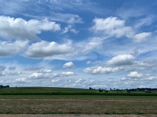 Clouds in sky with green rural pasture