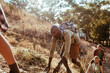 © Marko Geber - Man climbing steep trail during outdoor hike with friends