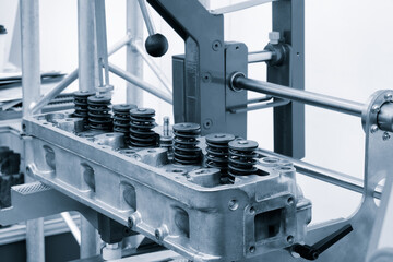 Aufkleber - A machine is working on a car engine. The engine is made of metal and has a lot of springs