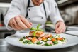 © Wed - Chef Garnishing Gourmet Dish in Professional Kitchen.