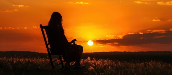 Silhouette of a woman watching the sunset