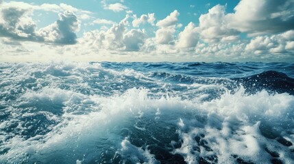 Powerful foamy sea waves rolling and splashing over water surface against cloudy blue sky