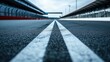 © pinporn manosri - Close-up of the starting grid on an empty racetrack, perfectly aligned and waiting for action.