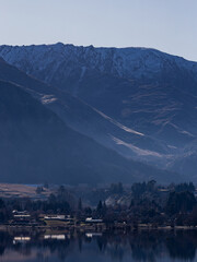 Wall Mural - Beautiful layer of mountains view from Lake Hayes, New Zealand.