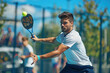 © kossovskiy - Man competing in a padel tennis match