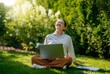 © Konstantin Yuganov - woman working on laptop in summer morning